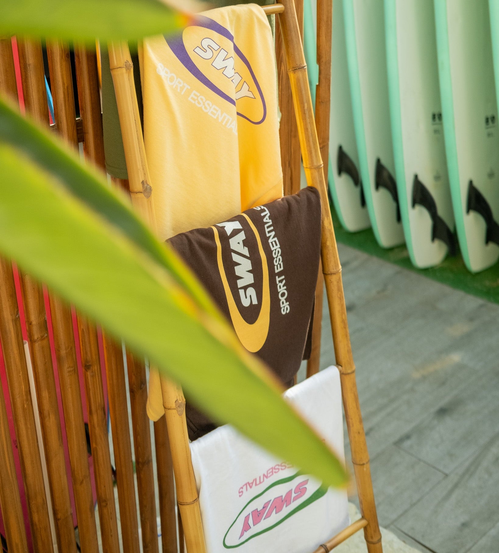 Paddles with 'Sway' branding on a rack with blurred background